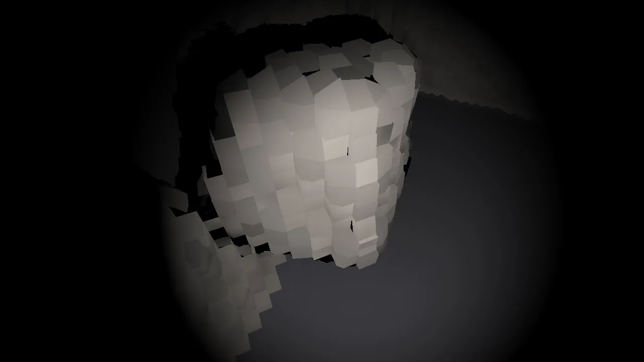 A block of voxel rock seen from above and to the side under a dim headlamp, its top uneven with loose voxels piled on it, dark cave around